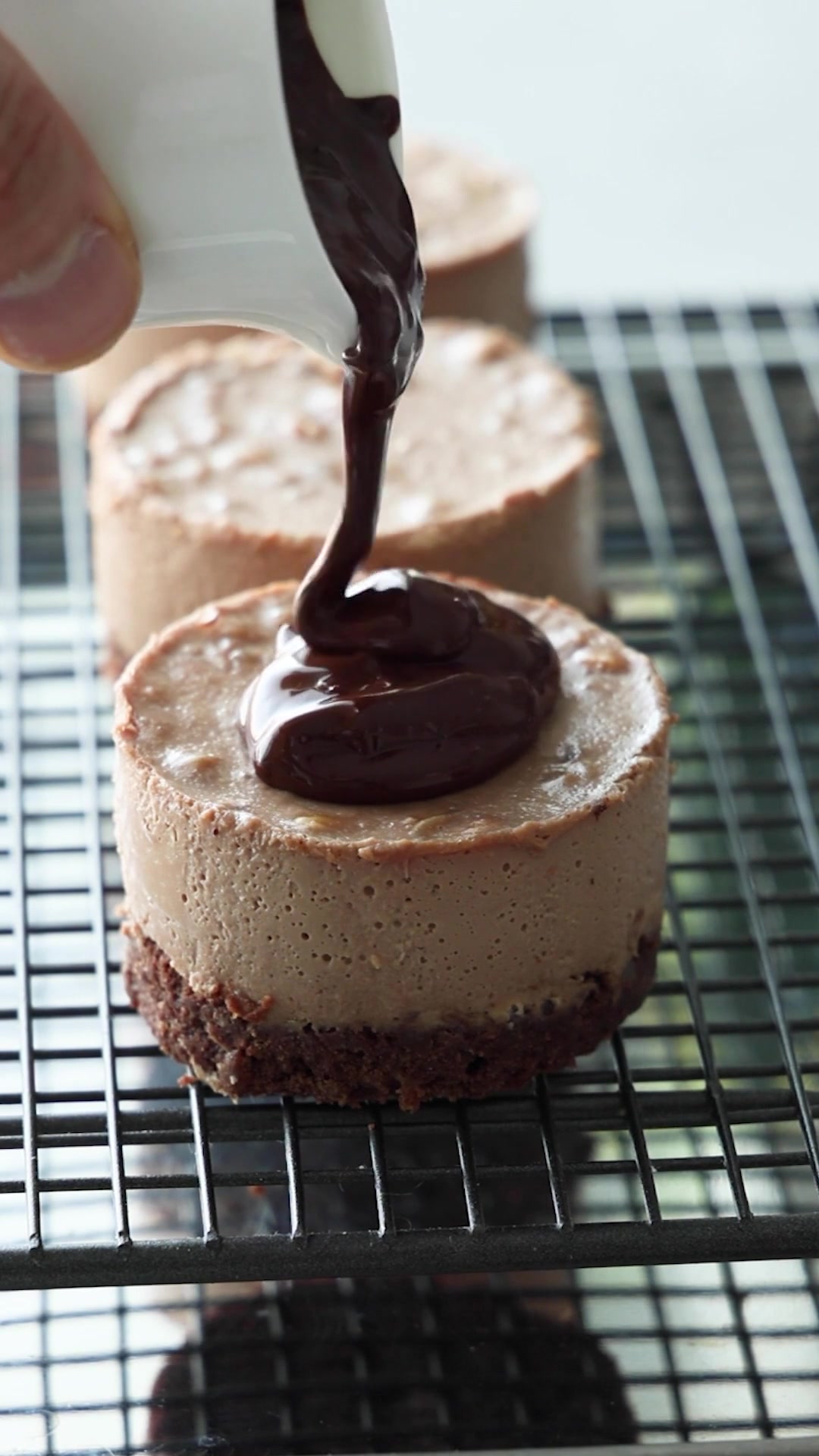 Chocolate glaze finishing an individual dessert cake
